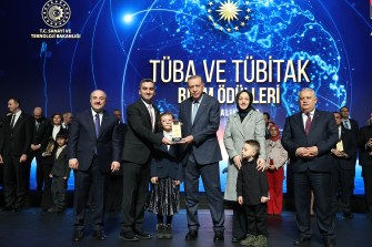 Abdullah Tirgil accepting award on stage