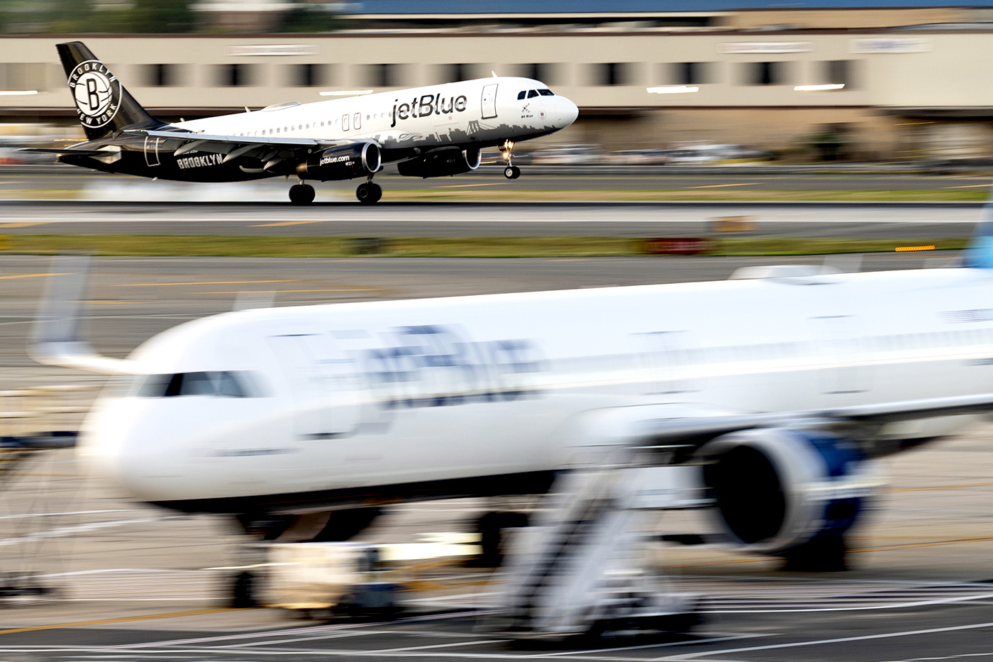 A JetBlue plane takes off from a runway