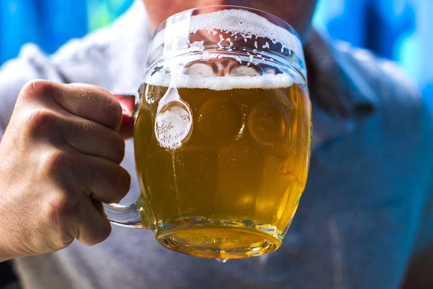 person holding mug of beer