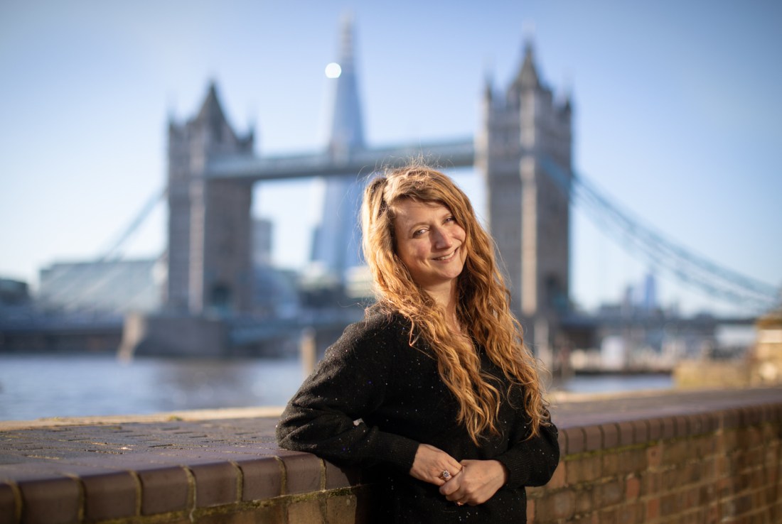 Headshot of Estelle Paranque in front of the Tower Bridge.