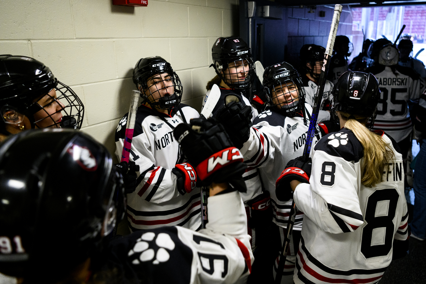northeastern womens hockey players lined up waiting to enter rink