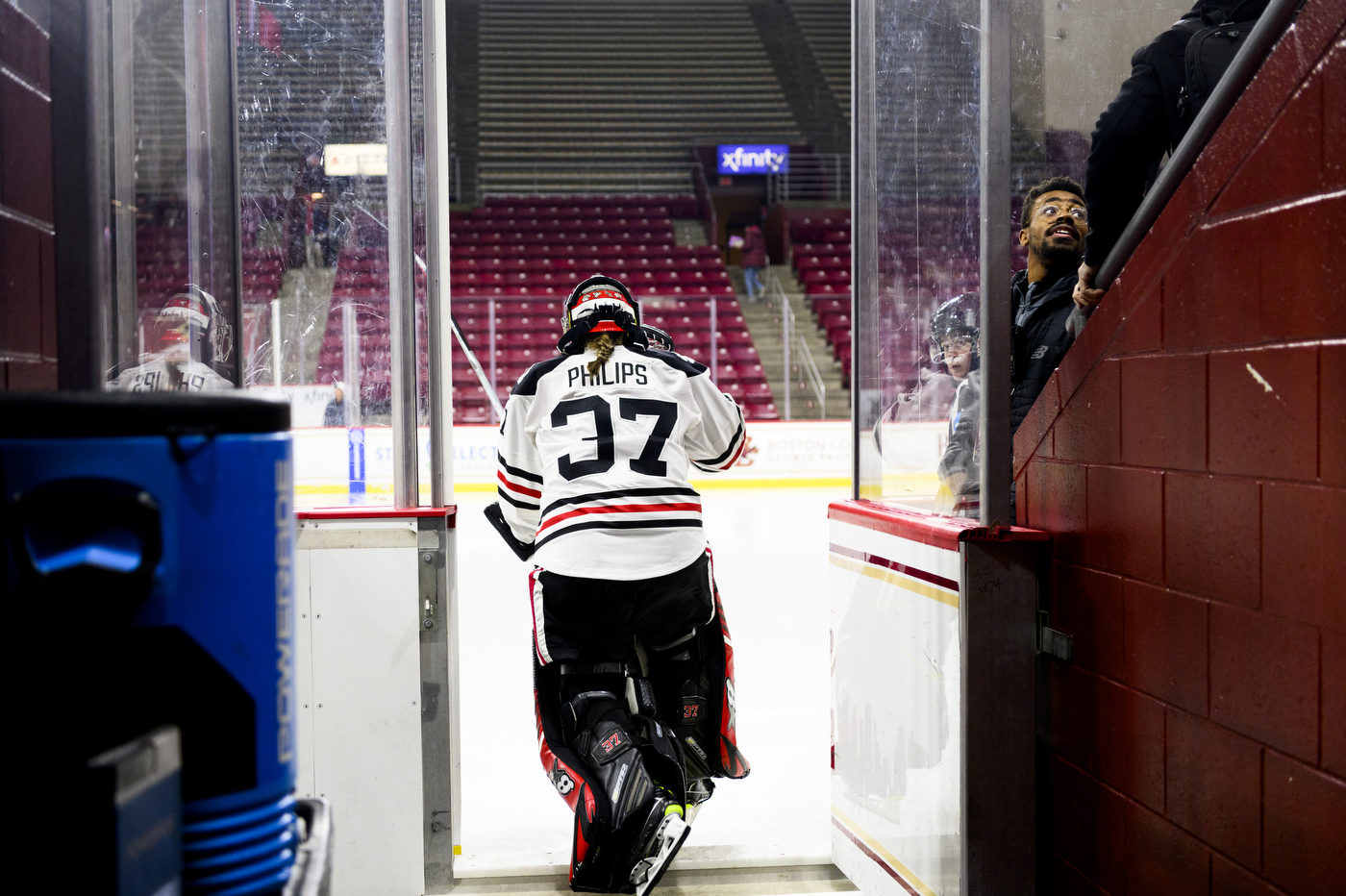northeastern womens hockey player stepping into the rink
