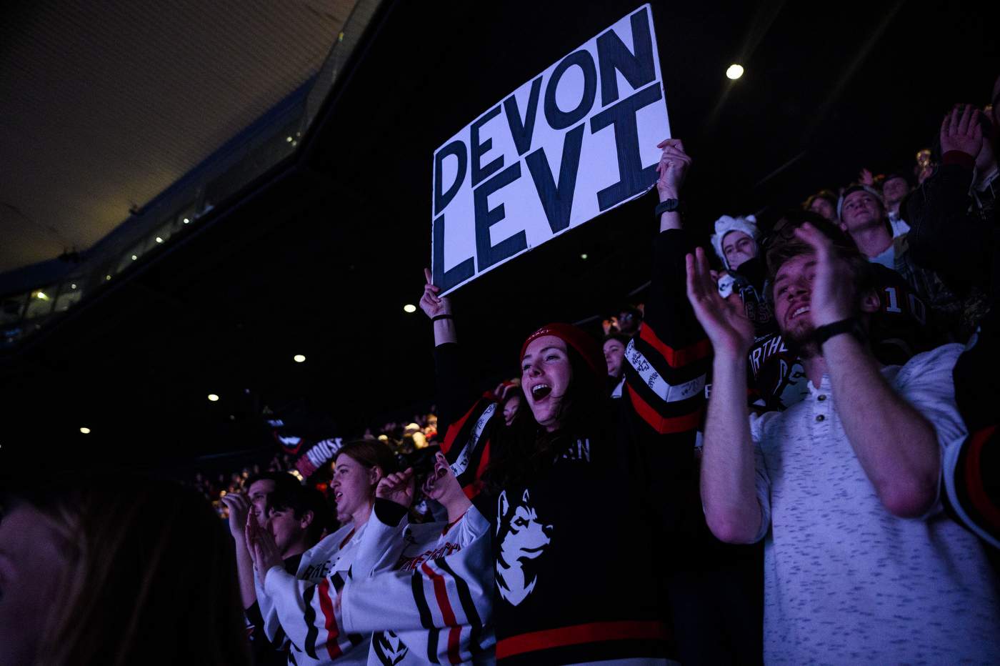 northeastern fan holding sign that says devon levi on it
