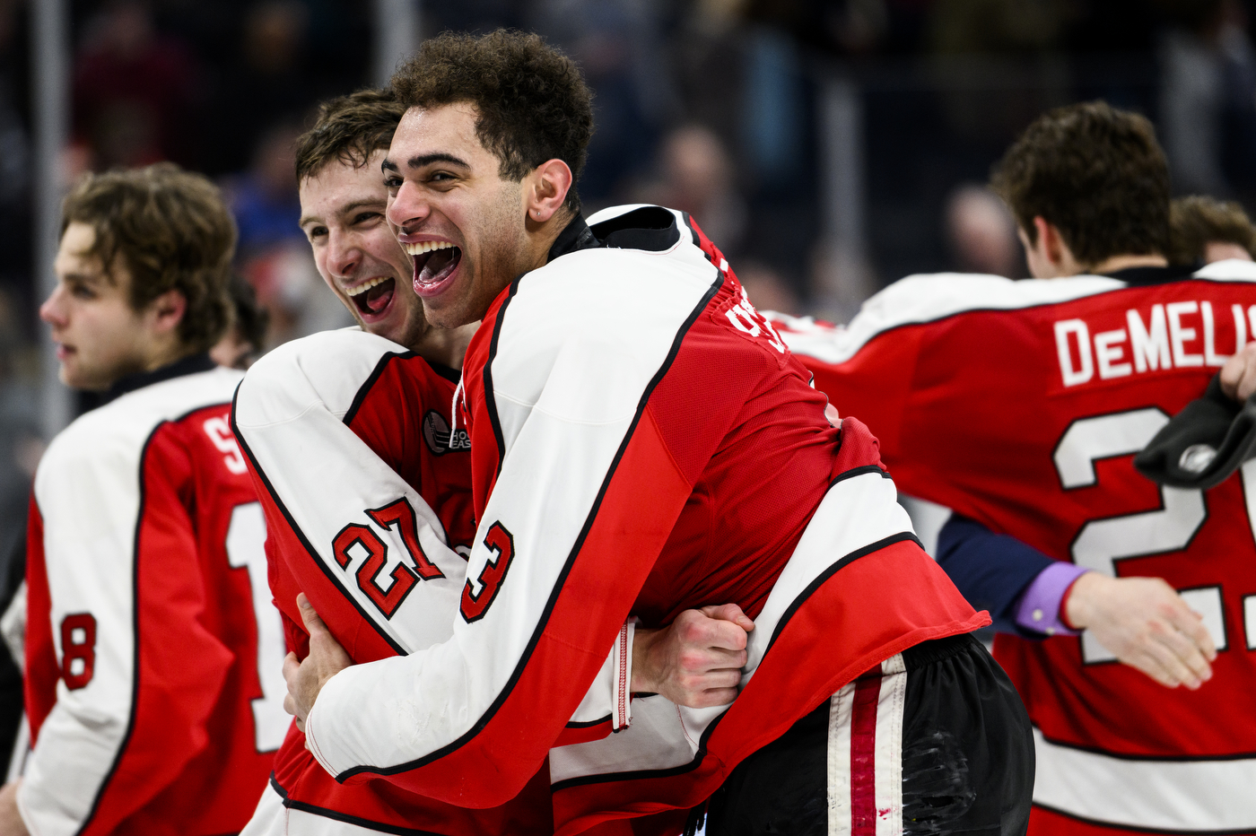 northeastern hockey players celebrating the beanpot win