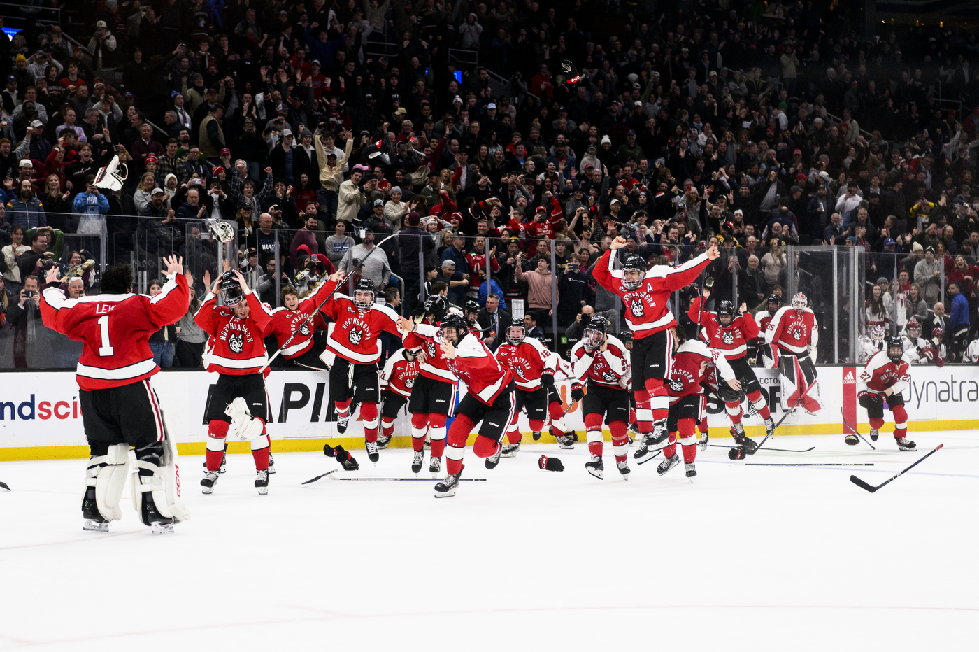 northeastern hockey players celebrate on the ice at td garden