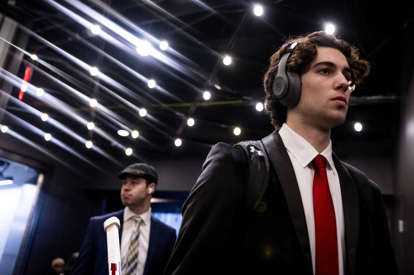 mens hockey player wearing a suit and headphones pre game