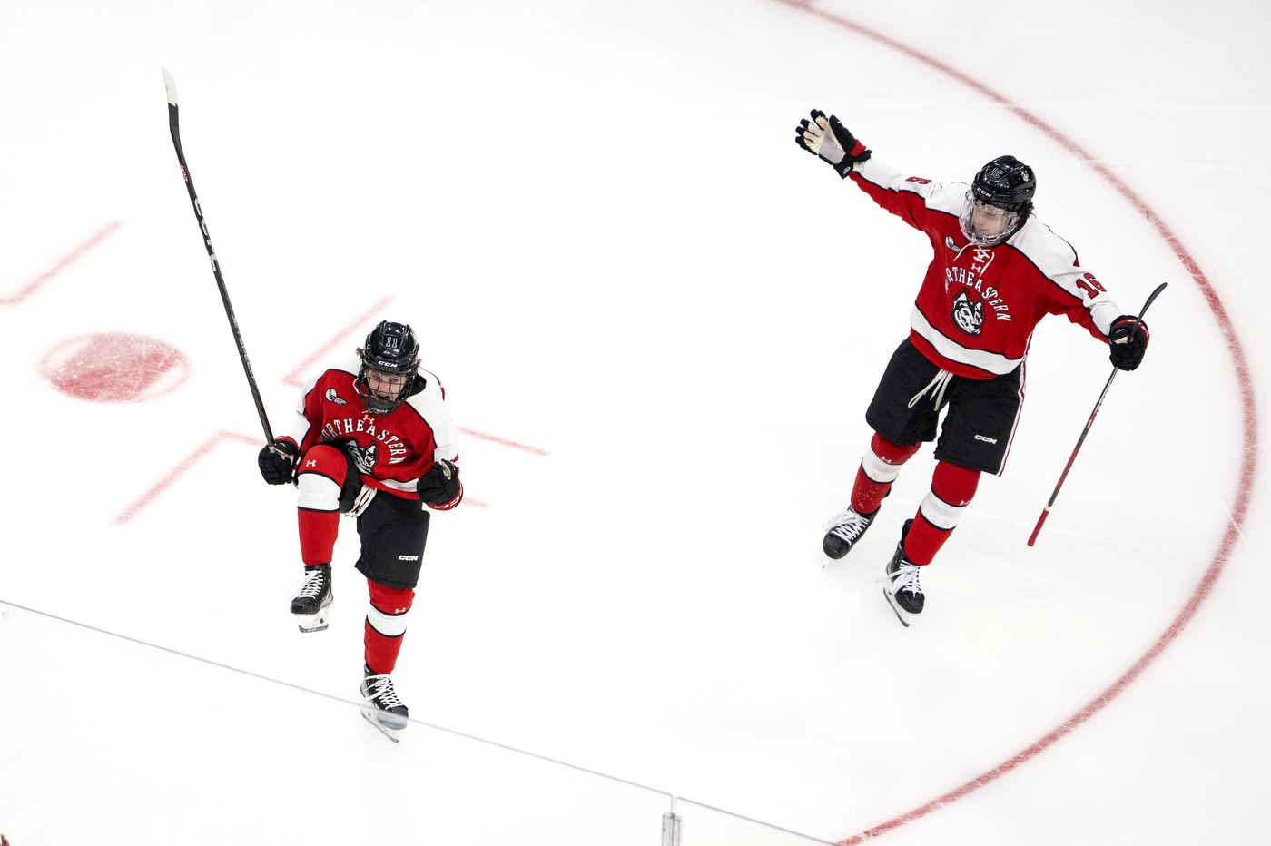 two hockey players celebrating on the ice