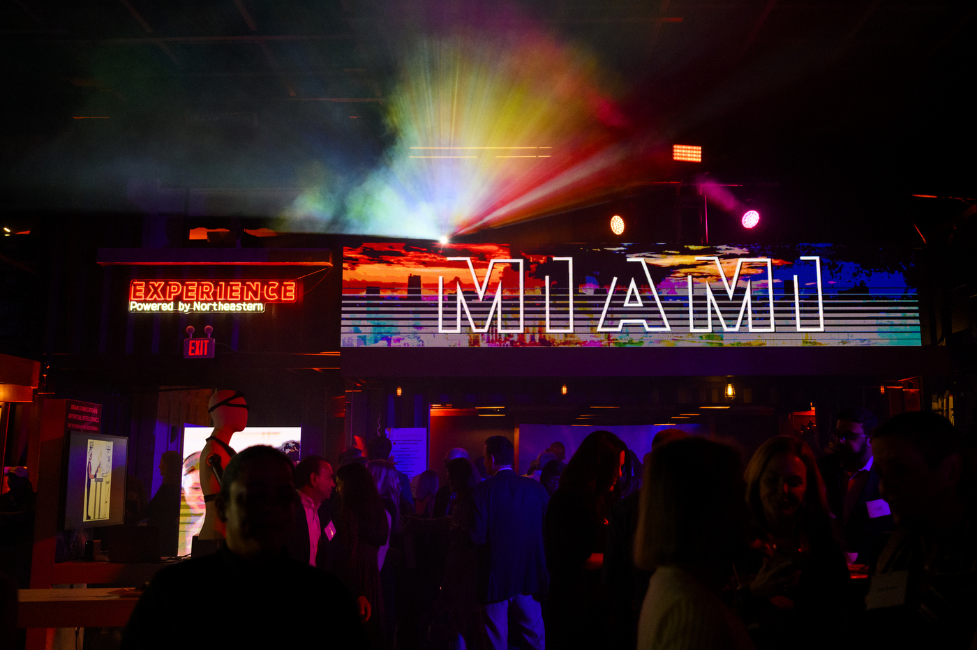The word 'Miami' is illuminated in multi-colored lights