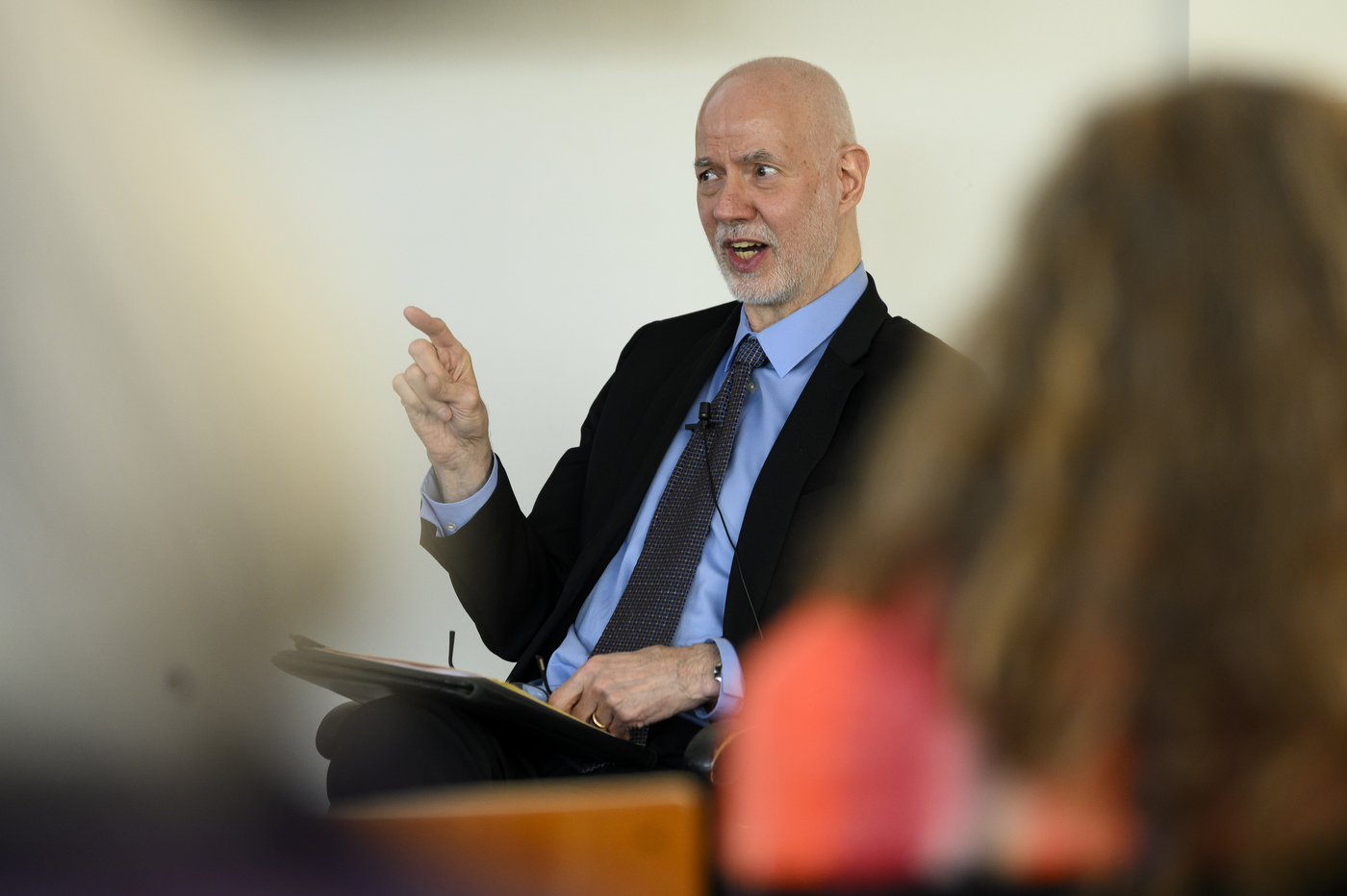 professor nick burbules gestures while speaking at the fireside chat