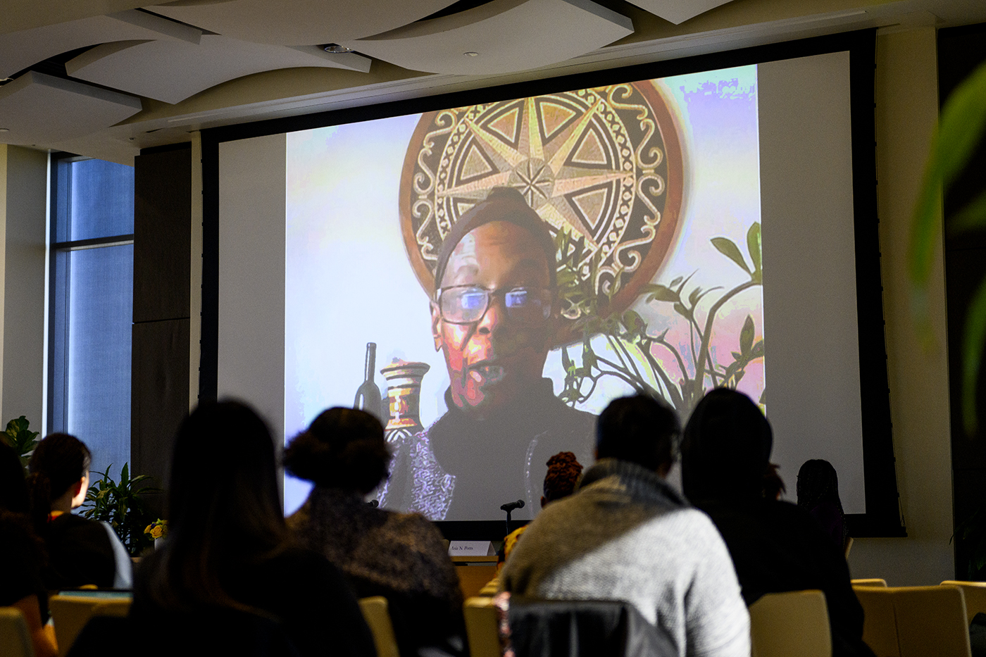 speaker projected on zoom at bell hooks symposium