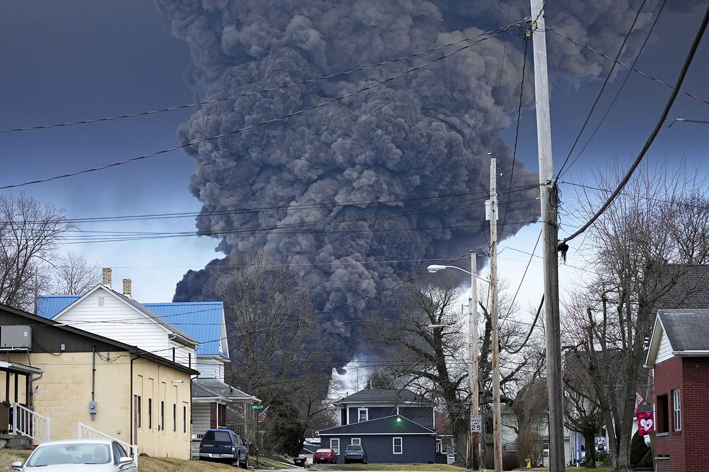 A cloud of black smoke fills the sky over homes and businesses over an Ohio town.