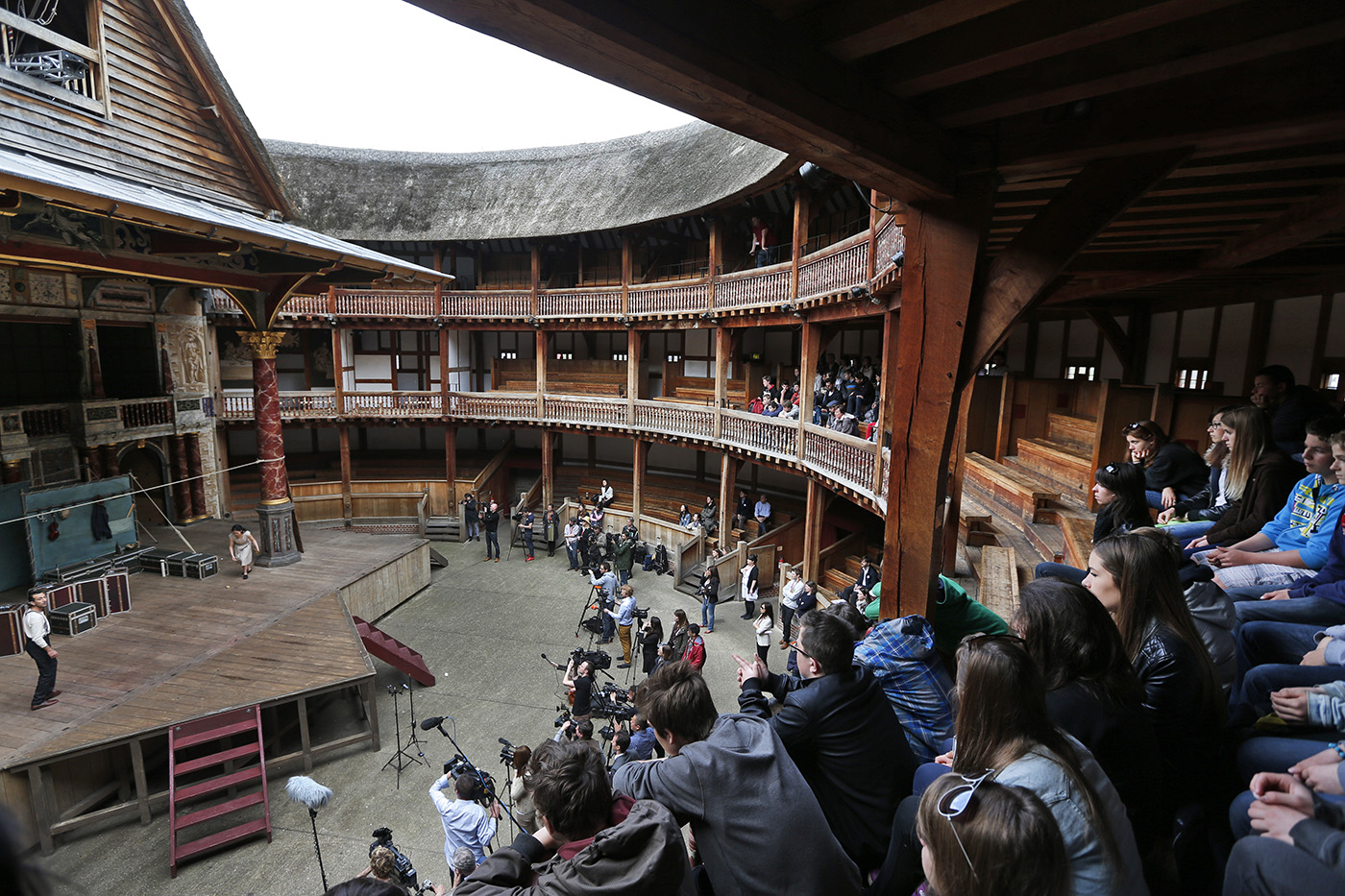 An audience sits in Shakespeare’s Globe theatre.