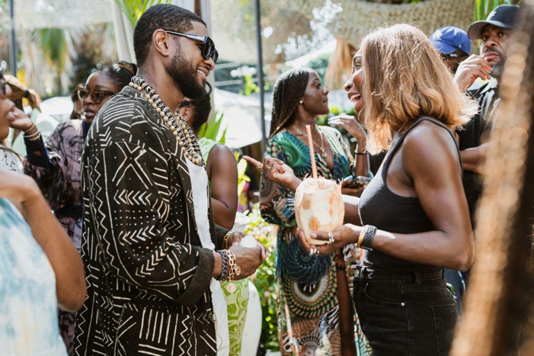 usher and michele cole talking together at a restaurant launch party