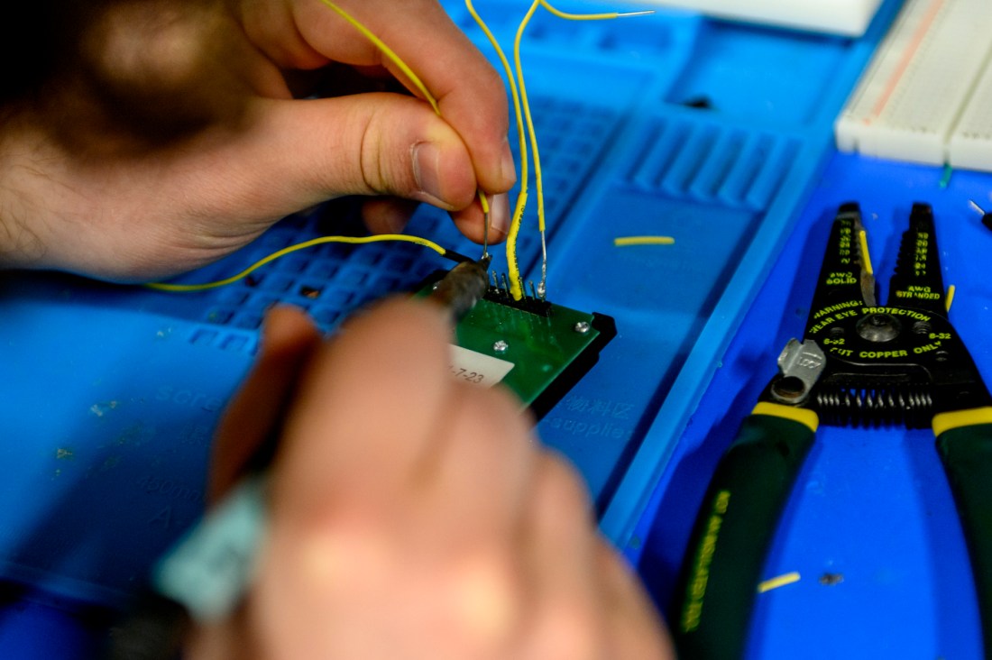 Nick Scaperdas soldering electrical wires together