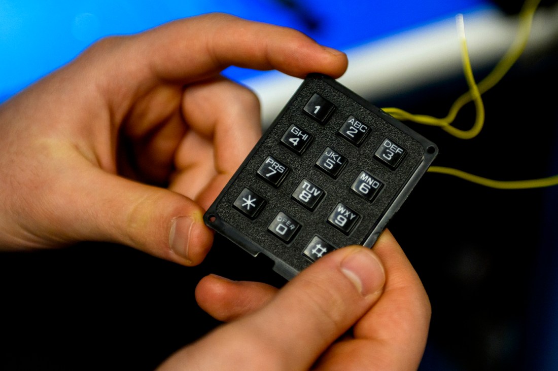 Nick Scaperdas holding a small keypad 