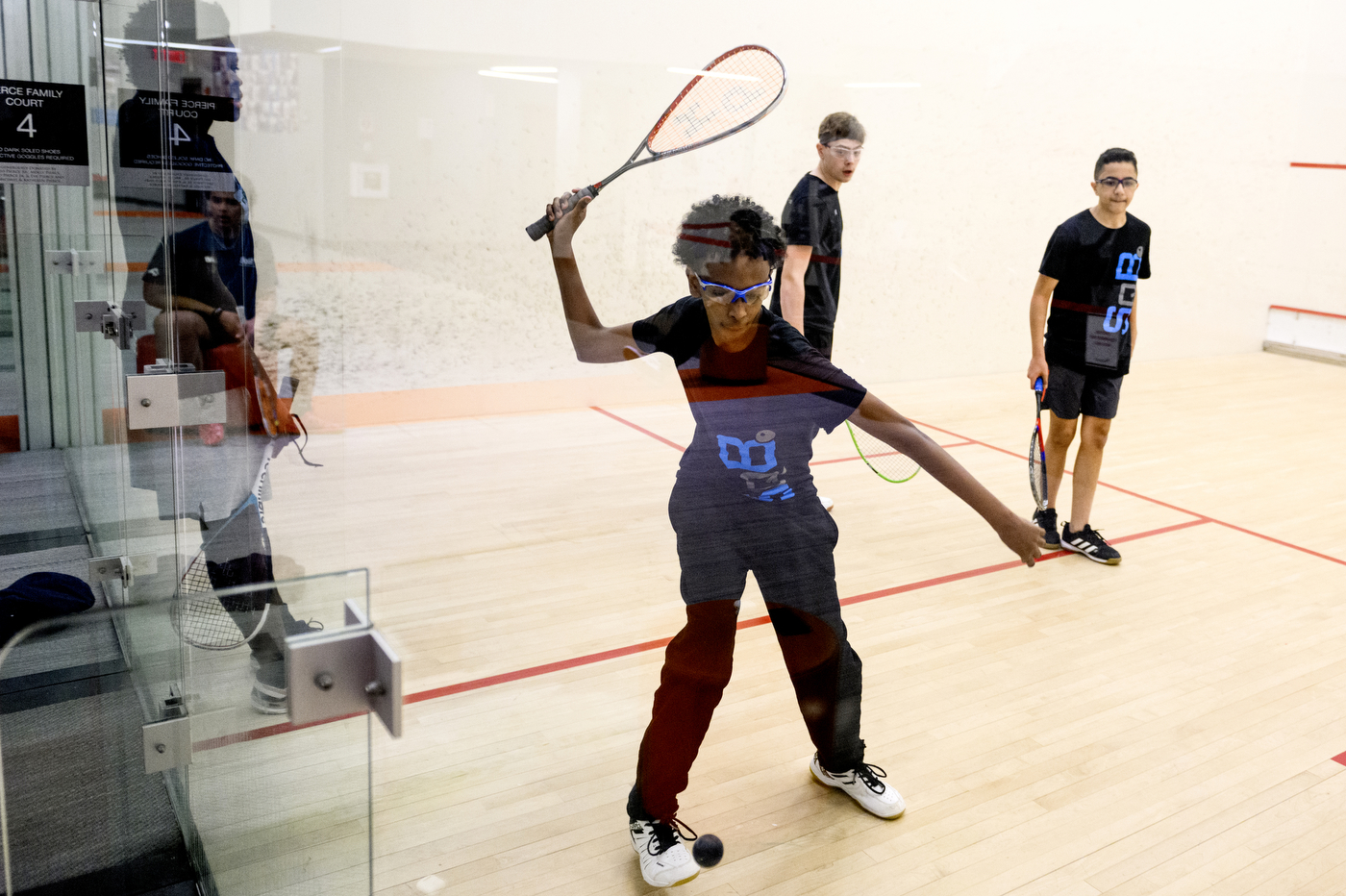people playing squash inside of SquashBusters