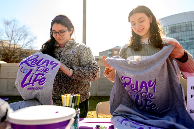 Maya Oberstein and Jessica Richards folding relay for life t-shirts