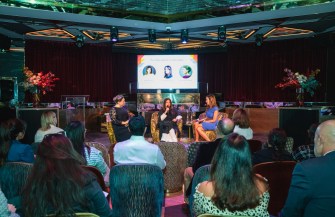 Nezha Alaoui, Jessica Michault, and Muna Al Gurg sit on stage talking at the Women Who Empower event in Dubai