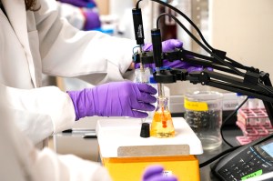 water researcher testing a water sample for PFAS in a lab