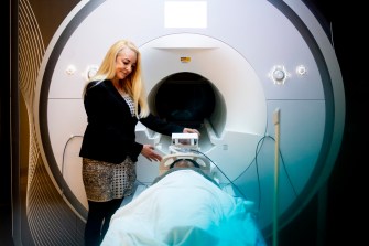 Susan Whitfield-Gabriel in front of a MRI machine