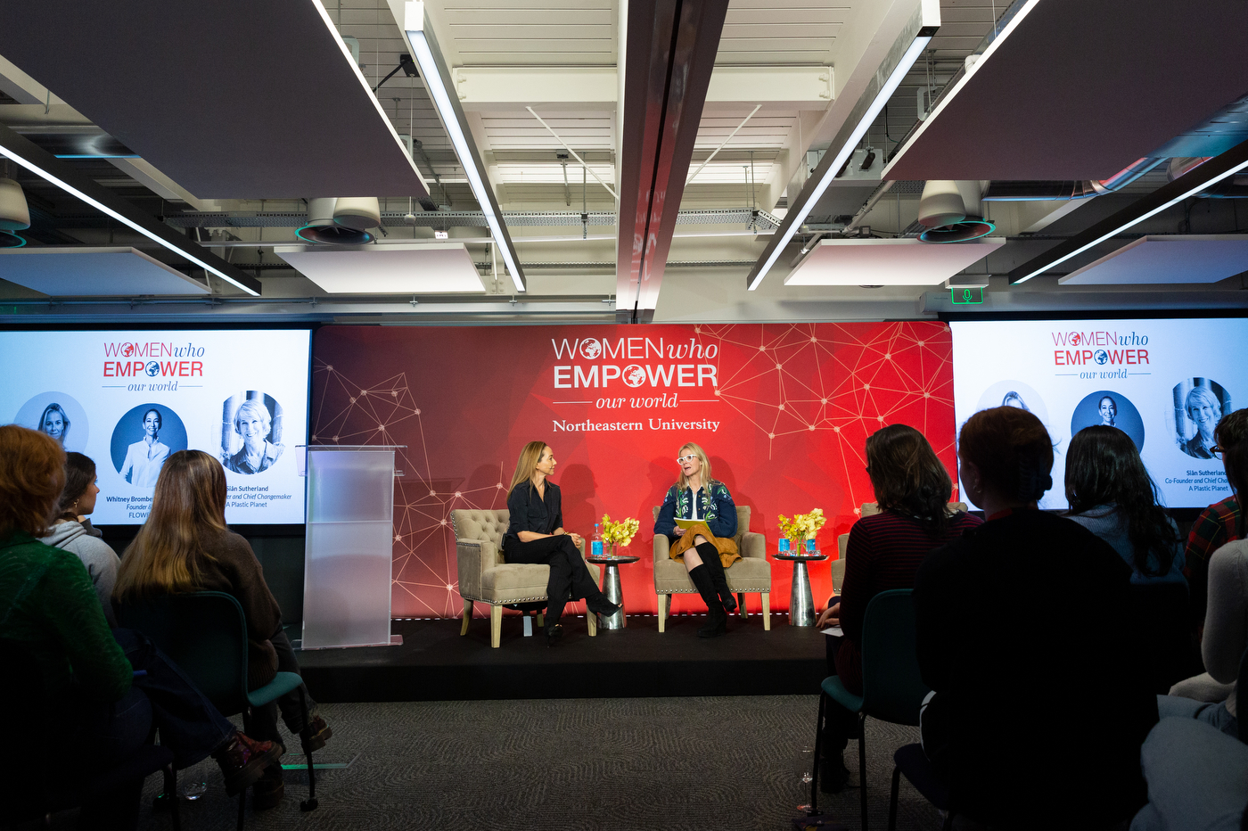 two women sitting on stage at women who empower our world event at northeastern university london