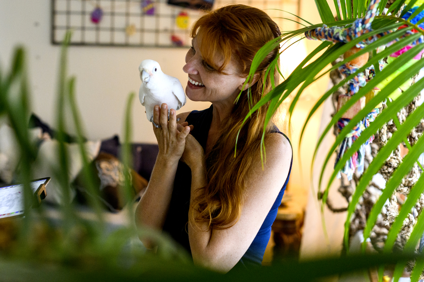 Jennifer Cunha holds a parrot.