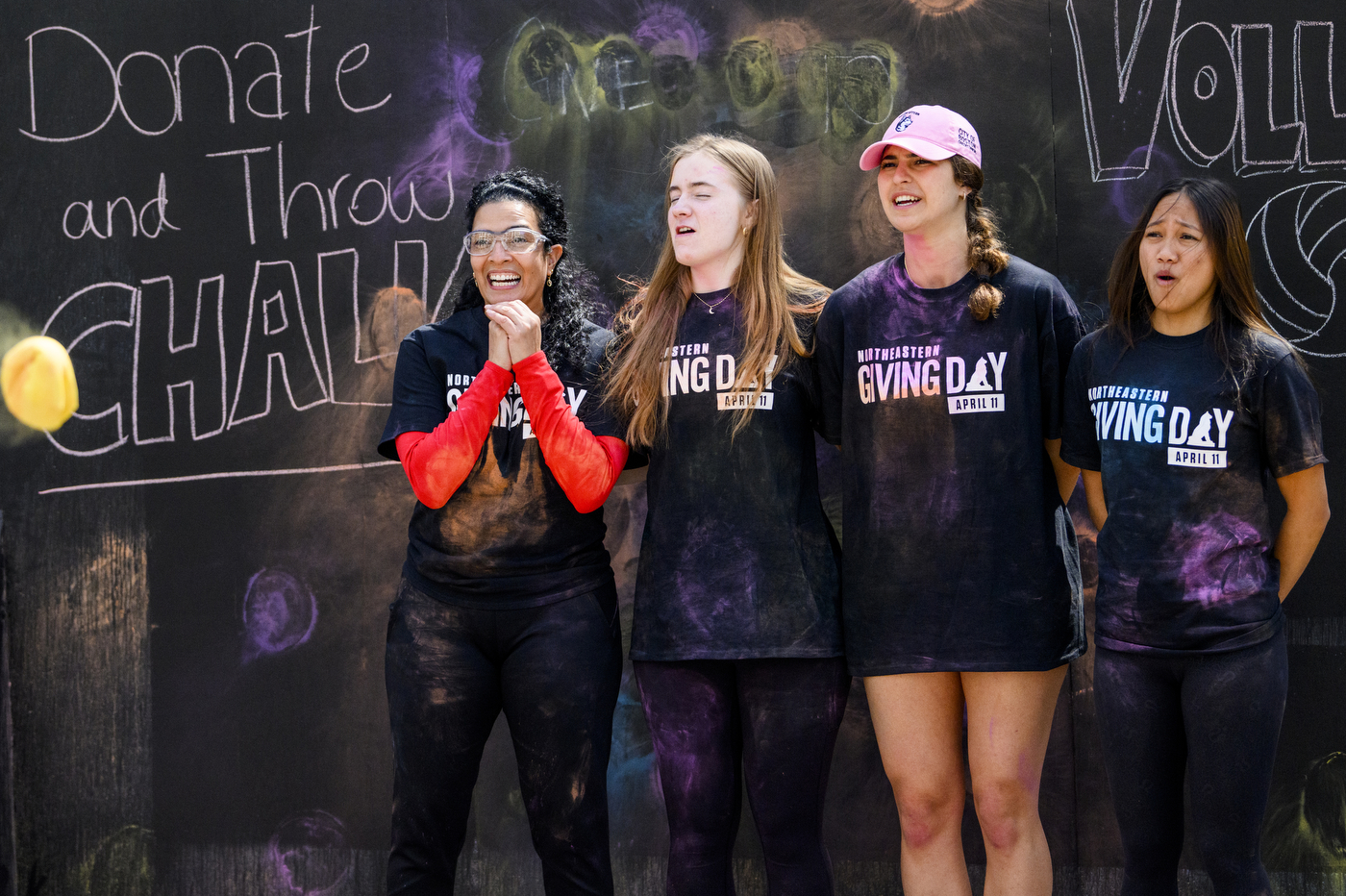 a group of students getting splattered with color bombs