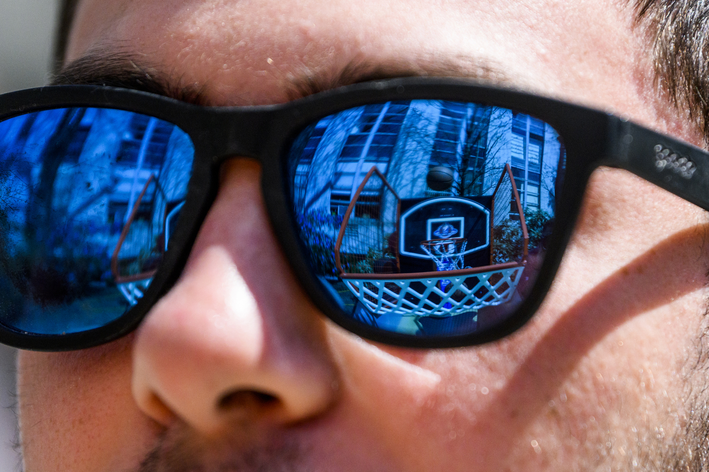 person wearing blue polarized sunglasses