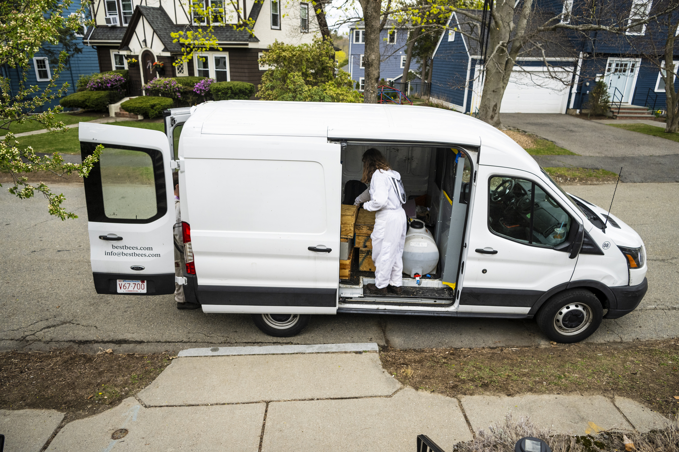 Katherine Antos stands inside of a van preparing equipment.