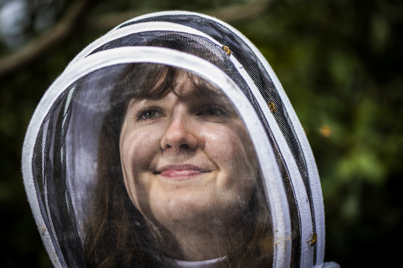 Headshot of Katherine Antos in her beekeeping suit. 