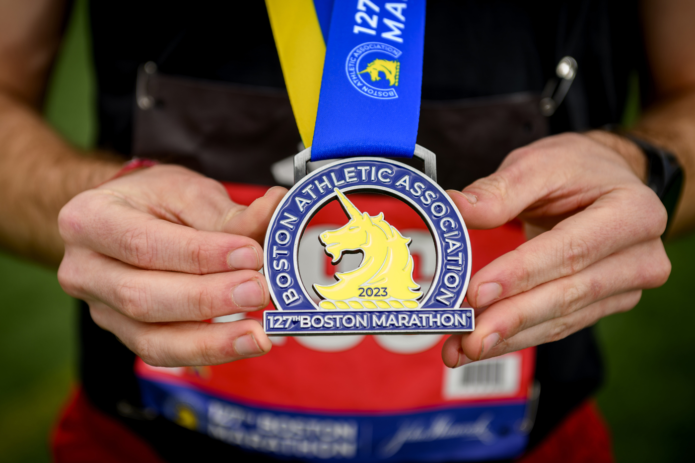 A closeup of Castronuovo's medal, saying 'Boston Athletic Association 2023, 127th Boston Marathon'