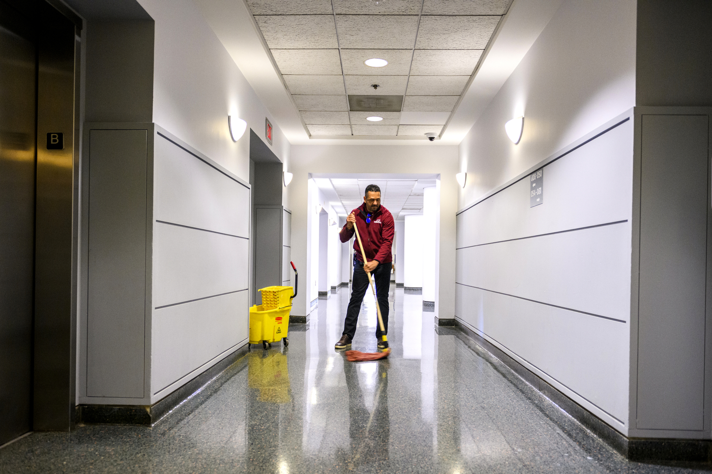 staff member of All Time Service cleaning a hallway