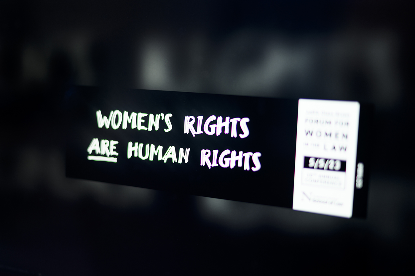 banner that says "WOMEN'S RIGHTS ARE HUMAN RIGHTS"