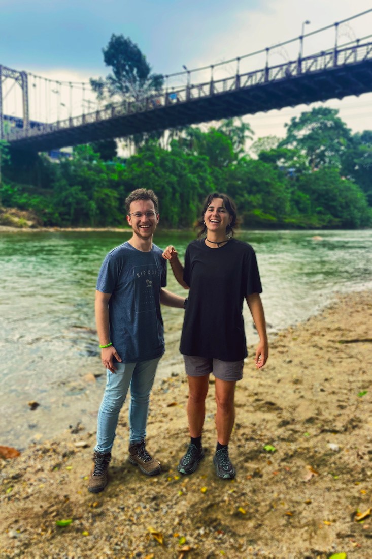 Brecker Ferguson posing with another person next to a river