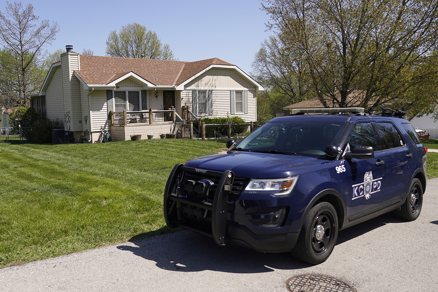 Police car parked outside of a home.