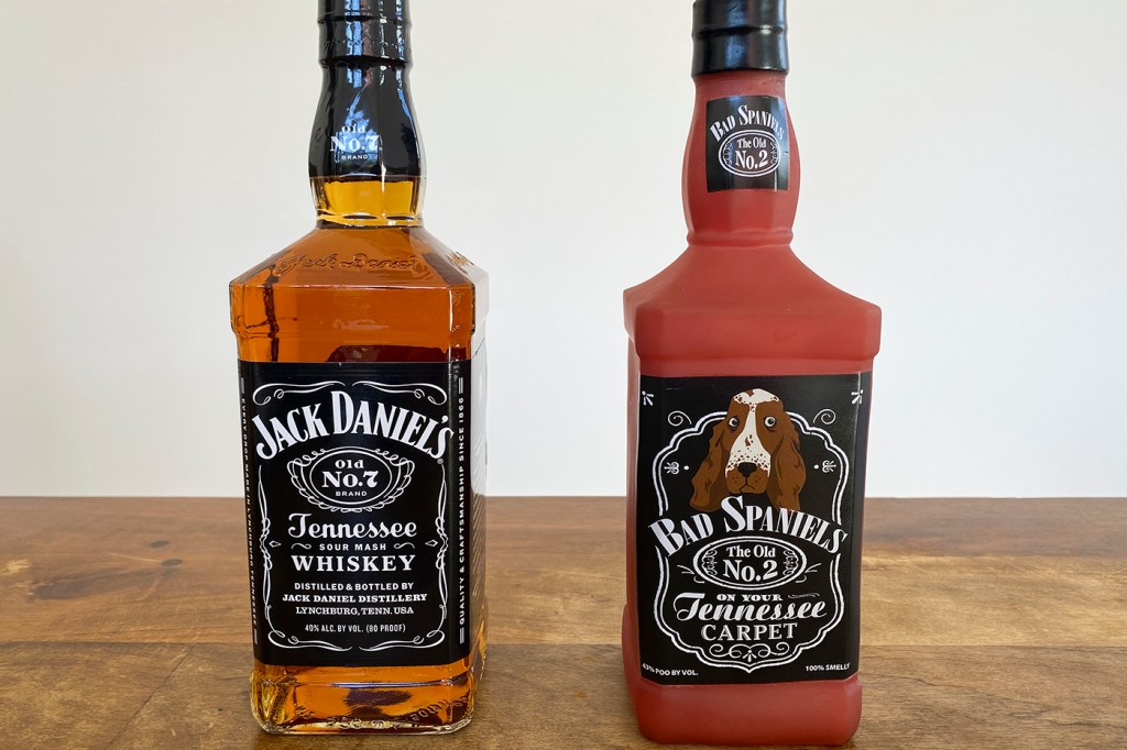 Jack Daniels bottle and Bad Spaniels dog toy side by side on a table