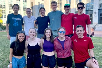Eleven students who are running the Boston Marathon pose on Northeastern's Boston campus.