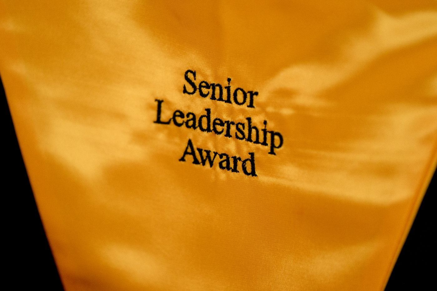 gold sash that has "Senior Leadership Award" embroidered on it