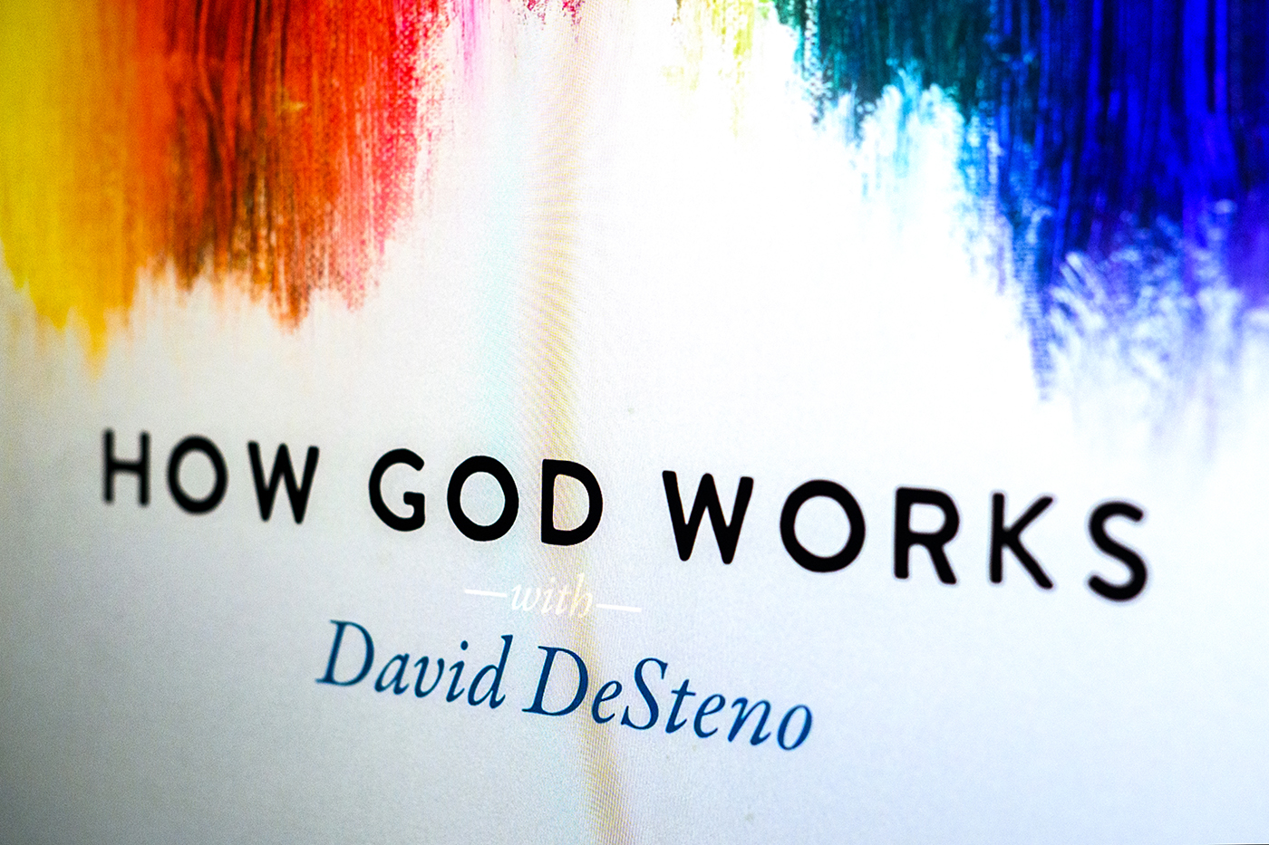 A logo that says "How God Works" with "David DeSteno" written below.