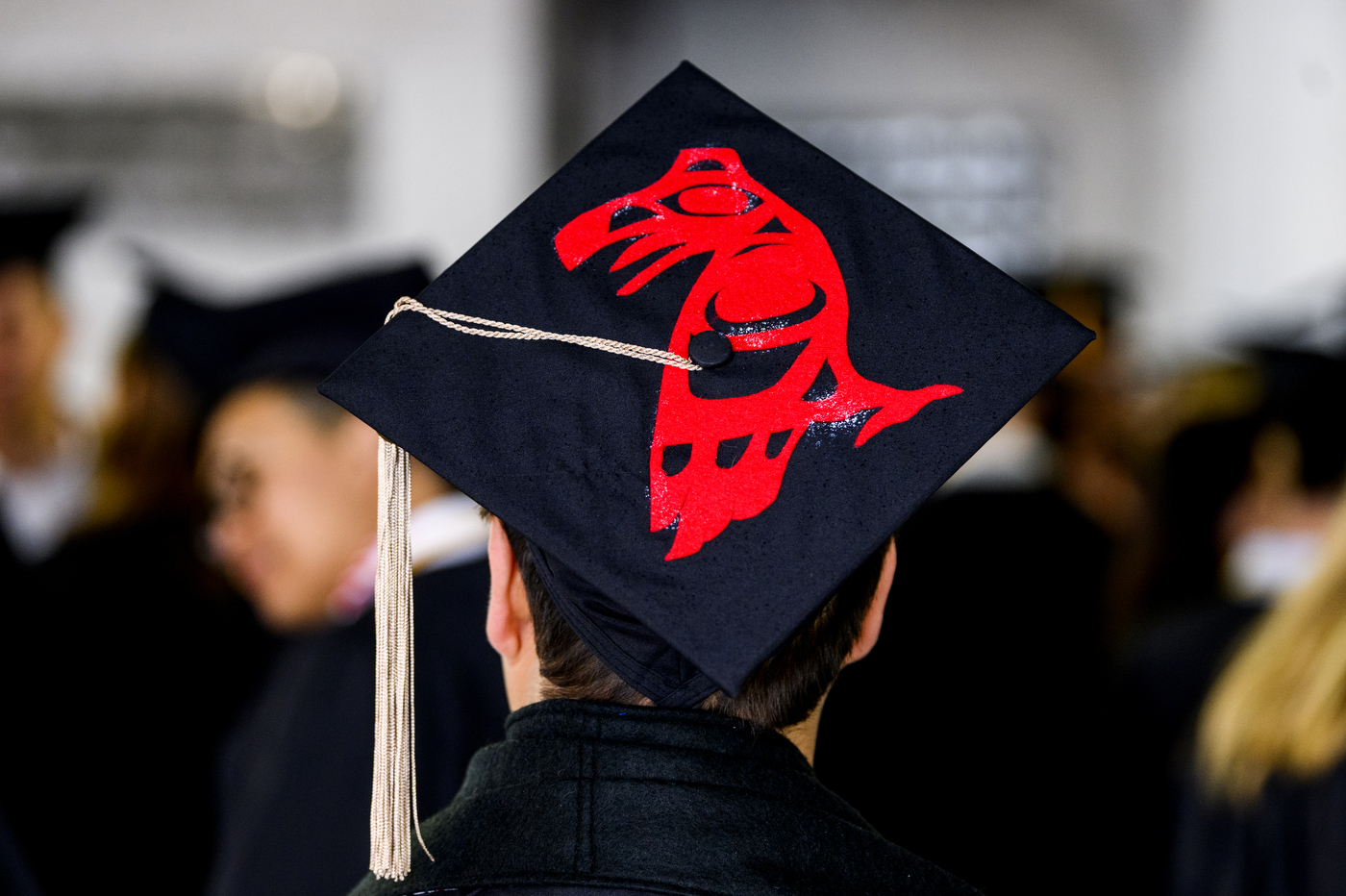 Christian Gomez showing his mortarboard.