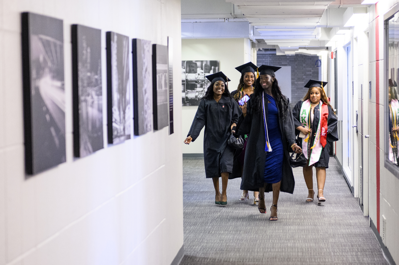 graduates walking down a hallway