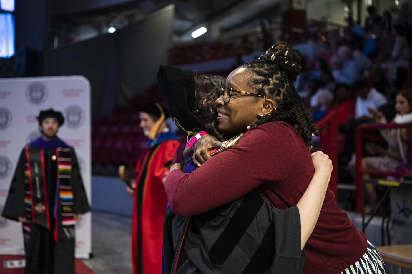 A graduate hugs Morgan Wilson.