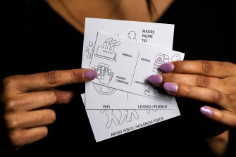 person holding NU LawLab trauma cards with pictures drawn on them