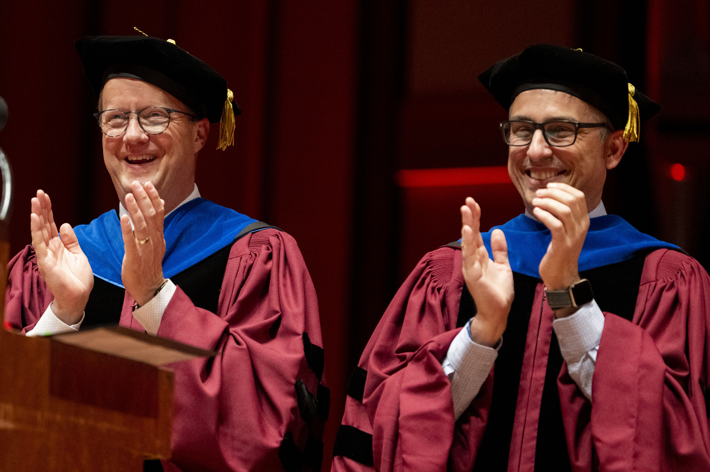 two graduates clapping