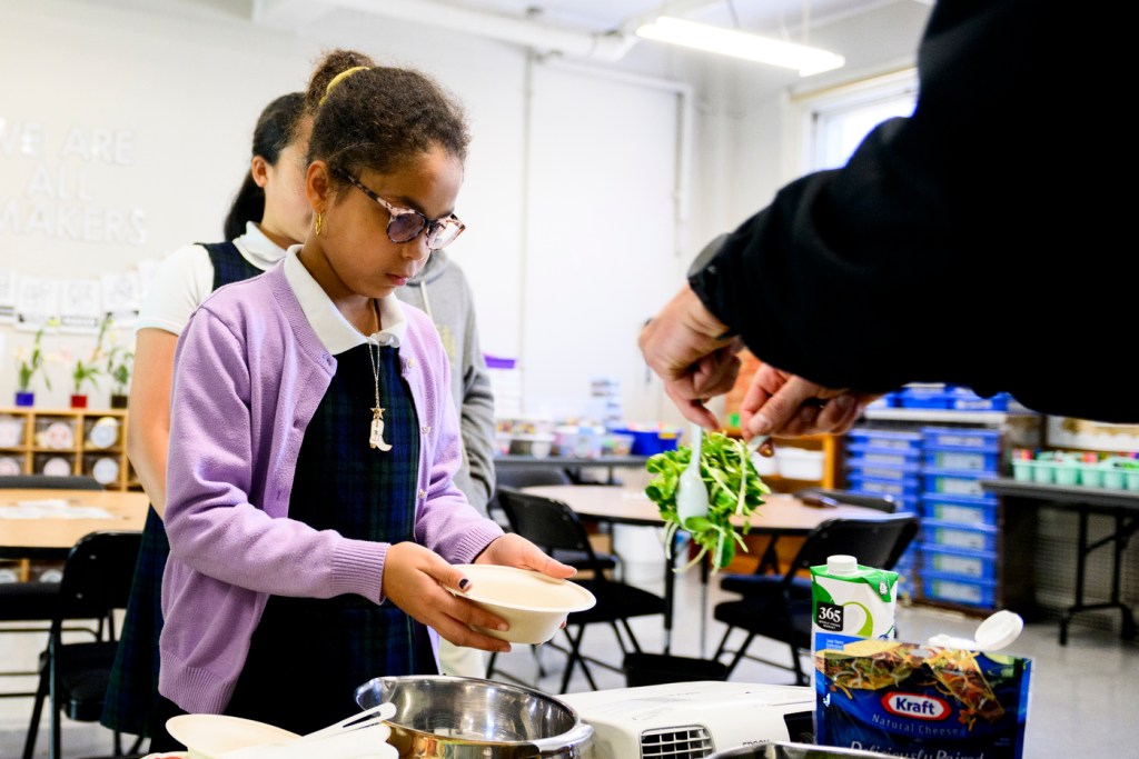 young student working with microgreens