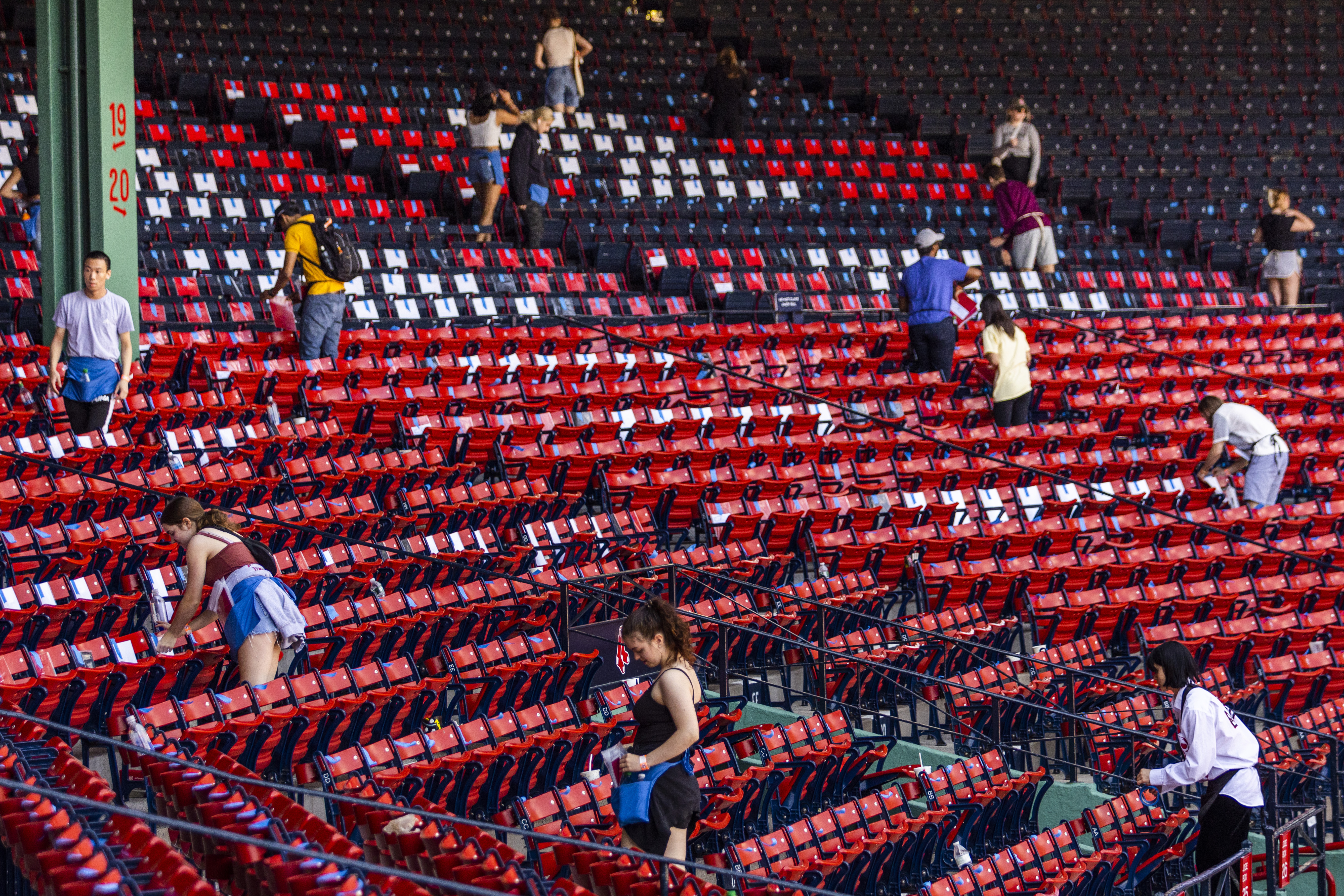 volunteers placing red cards on the seats at Fenway Park