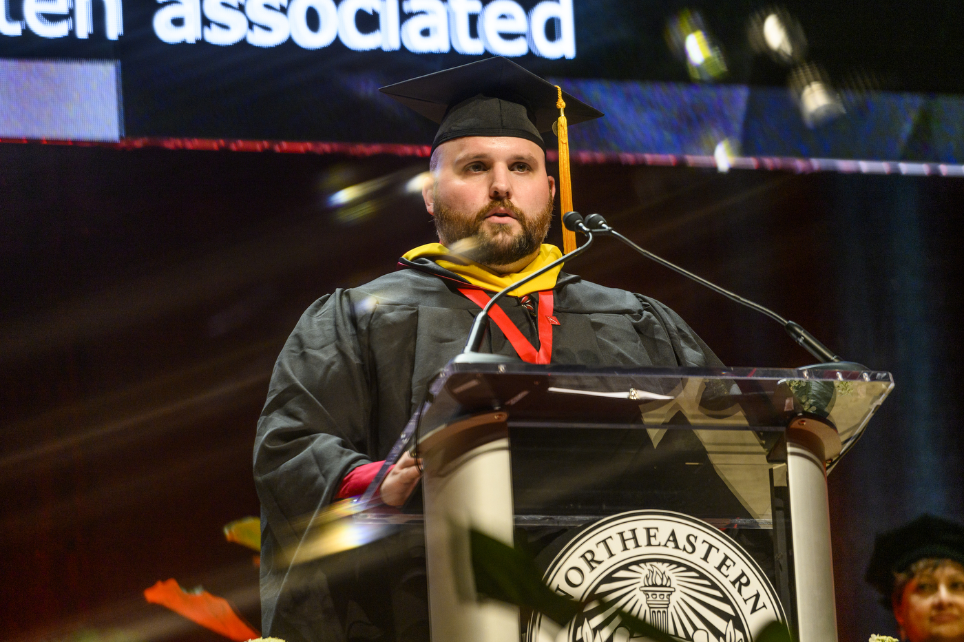 graduate speaking at podium