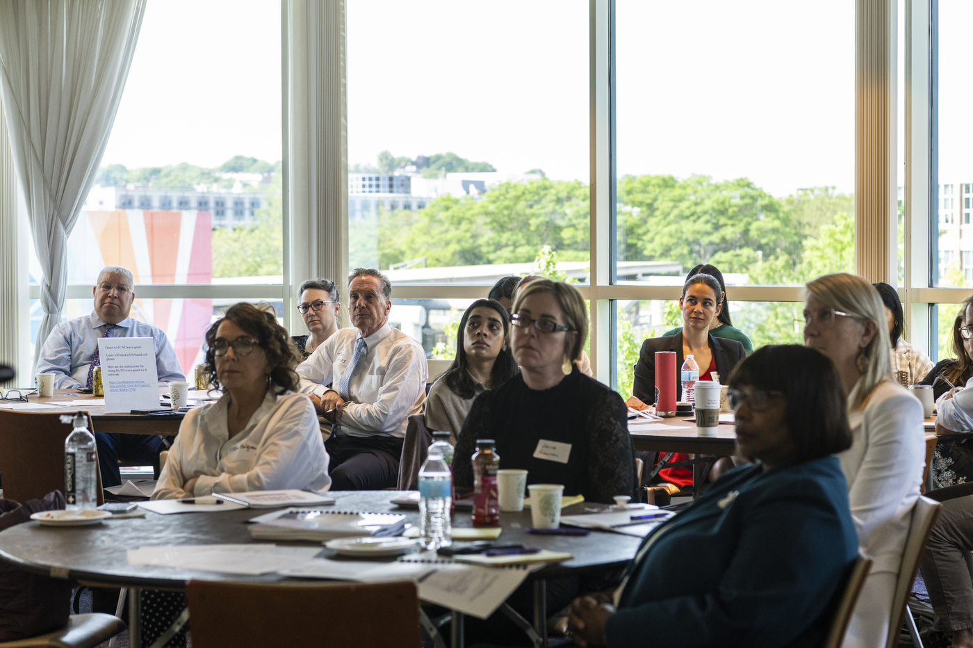 An audience listens during a program on social determinants of health.
