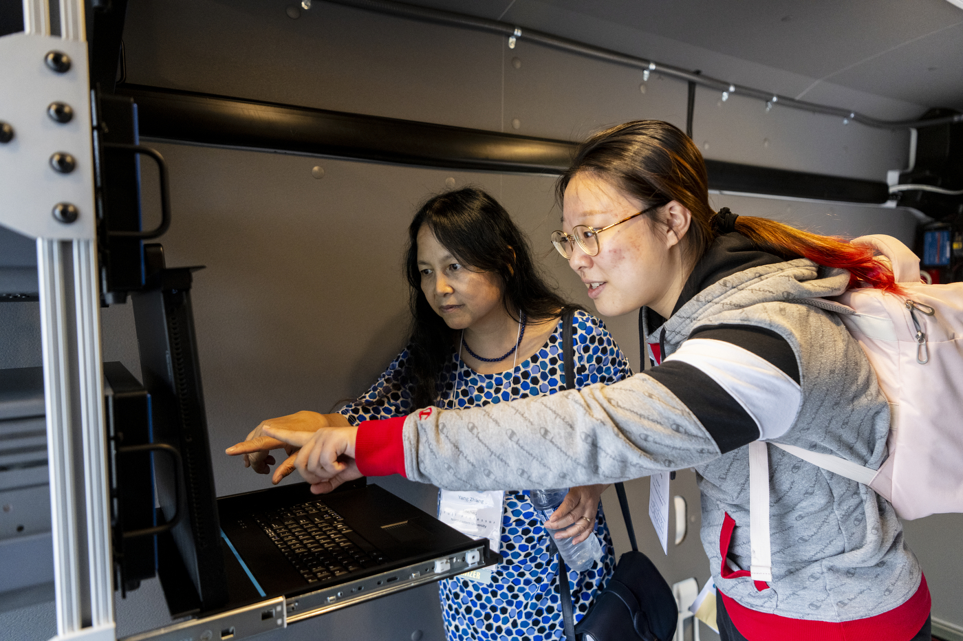 Yang Zhang and Yiyue Yang observe tools inside air quality mobile lab