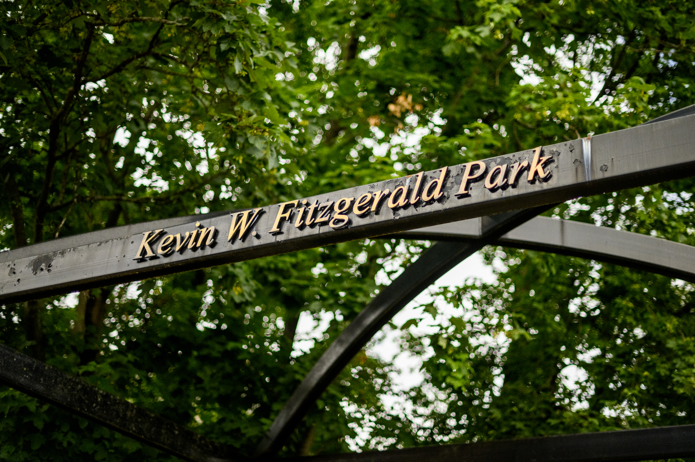 wooden arbor with "Kevin W Fitzgerald Park" on it